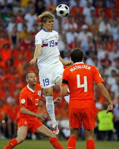 Russia's Roman Pavlyuchenko, center, Netherlands Joris Mathijsen, right, and Andre Ooijer, left, fight for the ball during the quarterfinal match between the Netherlands and Russia in Basel, Switzerland. Netherlands vs Russia