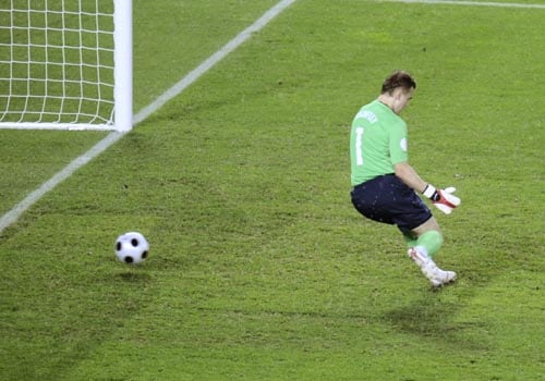 Russia's Igor Akinfeev fails to make a save as Spain's Xavi Hernandez, unseen, scores the opening goal during the semifinal match between Russia and Spain in Vienna, Austria. 2nd Semifinal - Russia vs Spain
