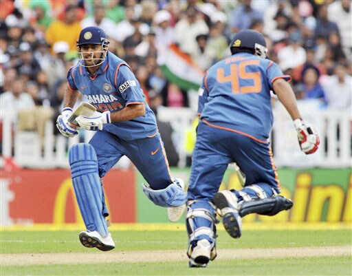 India's MS Dhoni crosses with Rohit Sharma against New Zealand on the 5th ODI match at Auckland on Saturday. (AP Photo) India win ODI series 3-1