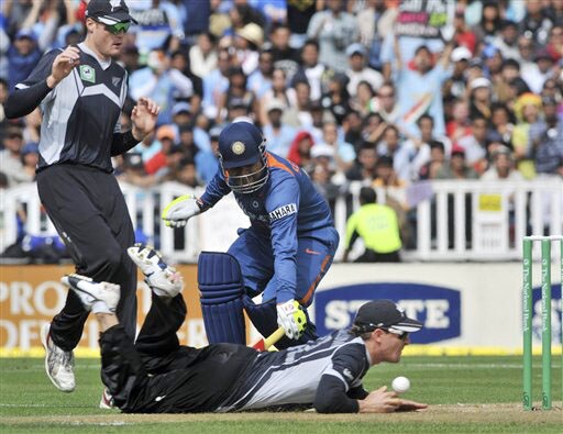Brendon McCullum slides in as Virender Sehwag makes his ground in the 5th ODI match at Auckland on Saturday. (AP Photo) India win ODI series 3-1