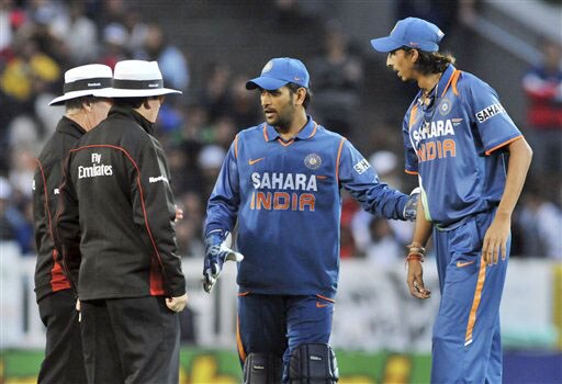Ishant Sharma with his captain MS Dhoni receives a warning for sledging from the umpires against New Zealand in the 5th ODI match at Auckland on Saturday. (AP Photo) India win ODI series 3-1