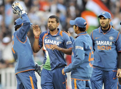 Praveen Kumar is congratulated by teammates after taking the Brendon McCullum's wicket in the 5th ODI match at Auckland on Saturday. (AP Photo) India win ODI series 3-1