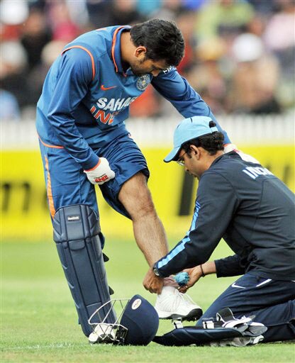 MS Dhoni receives treatment on his knee in the 4th ODI at Hamilton on Wednesday. (AP Photo) India vs New Zealand: 4th ODI
