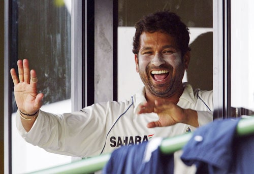 Sachin Tendulkar shares a light moment as he waves to spectators from the dressing room during the final day of a three day practice match between Sri Lanka A team and India in Colombo, Sri Lanka on July 20, 2008. India vs SLC XI, Day 3