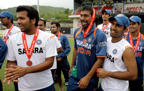 India's cricket players, from left, Rohit Sharma, Praveen Kumar, and Dinesh Karthik, celebrate after winning the One-Day International series against the West Indies at Beausejour in St. Lucia. (AP Photo) India win ODI series in WI