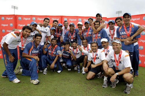 The India's cricket team pose for a photograph with their trophy and medals after winning the One-Day International series against the West Indies at Beausejour in St. Lucia. (AP Photo) India win ODI series in WI