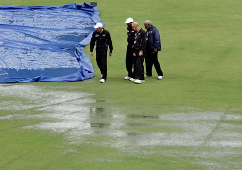Cricket umpires Nigel Llong, Clyde Duncan, Goaland Greaves and Clancy Mack inspect the pitch before declaring the abandonment due to weather of the fourth and final One-Day International match between India and the West Indies at Beausejour in St. Lucia. (AP Photo) India win ODI series in WI