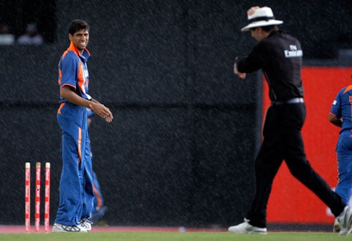 Ashish Nehra looks to the umpire Nigel Llong as he's calling to stop playing during a rain fall in the fourth and final One-Day International match against the West Indies at Beausejour in St. Lucia. (AP Photo) India win ODI series in WI
