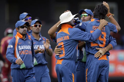 Ishant Sharma is embraced by teammates Yuvraj Singh and Harbhajan Singh after taking the wicket of West Indies' Chris Gayle, who was caught behind for a duck with the second ball of the fourth and final One-Day International match at Beausejour in St. Lucia. (AP Photo) India win ODI series in WI