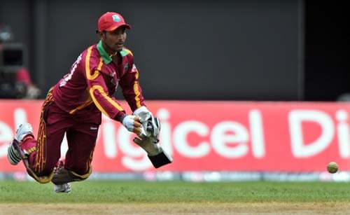 Denesh Ramdin successfully throws the ball to run out Mahendra Singh Dhoni during the first ODI against the India at the Sabina Park. (AFP Photo) 1st ODI: IND vs WI