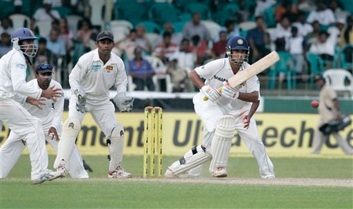 Indian batsman Sourav Ganguly, right, plays a shot as Sri Lankan wicketkeeper Prasanna Jayawardene, second from right, Mahela Jayawardene, third from right and Malinda Warnapura, left, look on during the third day's play of the first cricket Test between Sri Lanka and India in Colombo on Friday, July 25, 2008. India vs SL, 1st Test, Day 3