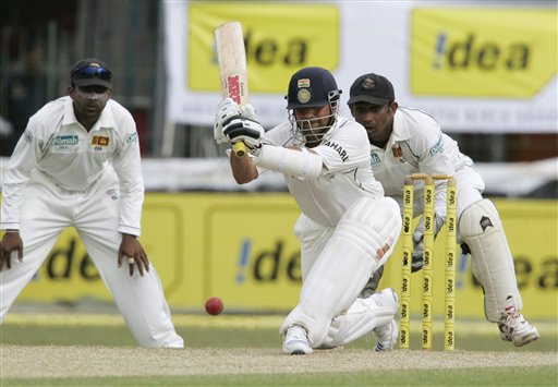 Sachin Tendulkar hits a shot as Sri Lankan wicketkeeper Prasanna Jayawardena and captain Mahela Jayawardene, left, look on during the third day's play of the first cricket Test between Sri Lanka and India in Colombo on Friday, July 25, 2008. India vs SL, 1st Test, Day 3