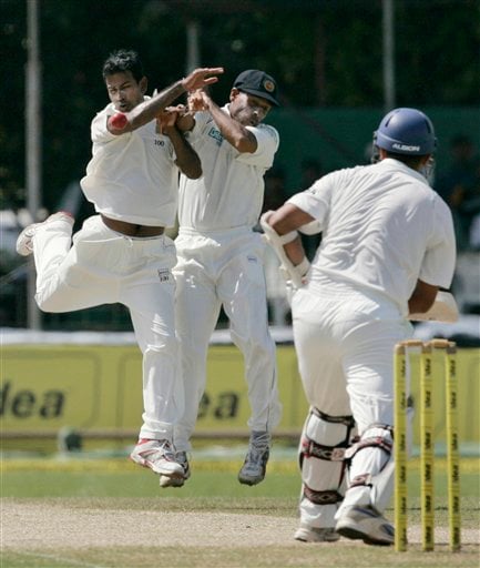 Nuwan Kulasekera, left, and fielder Thilan Samaraweera collide as they try to stop the ball, while Indian batsman Rahul Dravid looks on during the third day's play of the first Test cricket match between Sri Lanka and India in Colombo on Friday July 25, 2008. India vs SL, 1st Test, Day 3