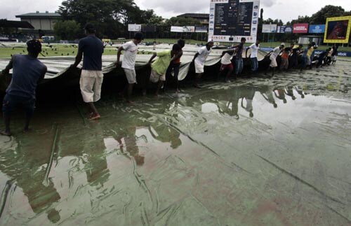 Ground staff at Colombo's SSC Stadium move the covers after overnight rain delayed the start of the first Test between India and Sri Lanka on Wednesday. India vs SL, 1st Test, Day 1