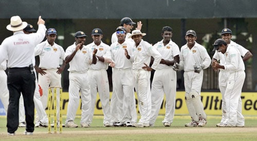 Sri Lankan cricketers celebrate as a ruling from the third umpire declares Gautam Gambhir (unseen) dismissed during the first day of the third Test between India and Sri Lanka in Colombo on August 8. 3rd Test, Day 1: India vs SL