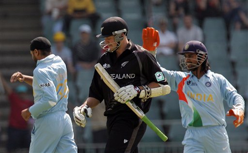 New Zealand's batsman Peter Fulton, center, reacts after his dismissal as India's bowler Harbhajan Singh, left, and teammate wicketkeeper Mahendra Singh Dhoni, right, celebrate during their Super Eight's Twenty20 World Championship cricket match against India at the Wanderers Stadium in Johannesburg, South Africa, Sunday, Sept. 16, 2007. India vs New Zealand