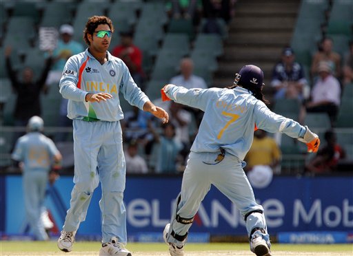 Yuvraj Singh, left, celebrates with his captain Mahendra Singh Dhoni, right, after dismissing New Zealand's batsman Ross Taylor, not pictured, for 11 runs during their Super Eight's Twenty20 World Championship cricket match against New Zealand at the Wanderers Stadium in Johannesburg, South Africa, Sunday, Sept. 16, 2007. India vs New Zealand