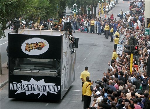 The Knight Riders cricket team drives past during a parade through the streets of Cape Town, ahead of the Indian Premier League Twenty20 matches to be held over the weekend in Cape Town. (AP Photo) IPL-II caravan rolls out in SA