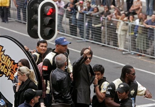 Indian movie star and owner of the Knight Riders team Shah Rukh Khan, center, gives a thumbs up during a parade through the streets of Cape Town, ahead of the Indian Premier League Twenty20 cricket matches to be held over the weekend in Cape Town on Thursday. (AP Photo) IPL-II caravan rolls out in SA