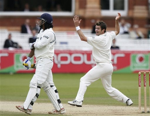 India's Mahendra Dhoni, left, holds his arm as England's James Anderson appeals for his wicket during the fifth day of the first Test at Lord's cricket ground, London on Monday. India vs England, 1st Test - Day 5