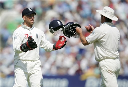 England's wicketkeeper Matthew Prior, left, is handed two helmets by teammate Andrew Strauss as they play India on the second day of the third cricket test at the Oval cricket ground in London on Friday. India vs England, 3rd Test - Day 2