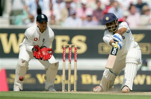 India's Mahendra Dhoni drives the ball as keeper Matthew Prior looks on, left, on the second day of the third cricket test at the Oval cricket ground in London on Friday. India vs England, 3rd Test - Day 2
