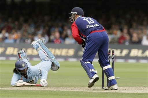 England's Matt Prior, right, breaks the wicket and India's Ramesh Powar, left, is run out during the final one day international cricket match at Lords, London on Saturday. India vs England - 7th ODI