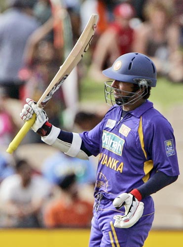 But Kumar Sangakkara carries on after Jayawardene’s departure. Here, he raises his bat after scoring his hundred. 8th match - India vs Sri Lanka