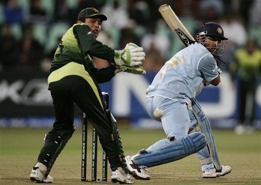 Mahendra Singh Dhoni, right, plays a shot as Pakistan's wicket keeper Kamran Akmal looks on during Twenty20 World Championship Cricket match in Durban, South Africa, Friday, Sept. 14, 2007. India vs Pakistan