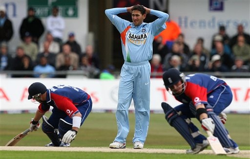 Ajit Agarkar, centre, holds his head as England's Matt Prior, left, and Ian Bell, right, score runs during the fifth one day International match Headingley Cricket ground in Leeds, England, Sunday Sept. 2, 2007. India v England - 5th ODI