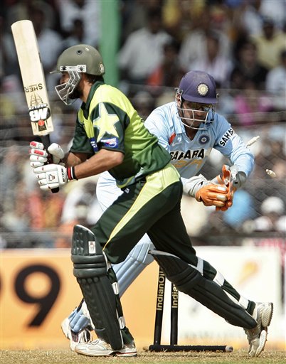 Mahendra Dhoni, right, removes the bails for the dismissal of Pakistan's Shahid Afridi during the first one day international cricket match in Gauhati, India Monday, Nov. 5, 2007. Ind v Pak - 1st ODI
