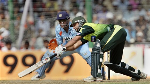 Pakistan's Shahid Afridi, right, attempts to play a shot as India's Mahendra Dhoni looks on, during the first one day international cricket match in Gauhati, India Monday, Nov. 5, 2007. Ind v Pak - 1st ODI