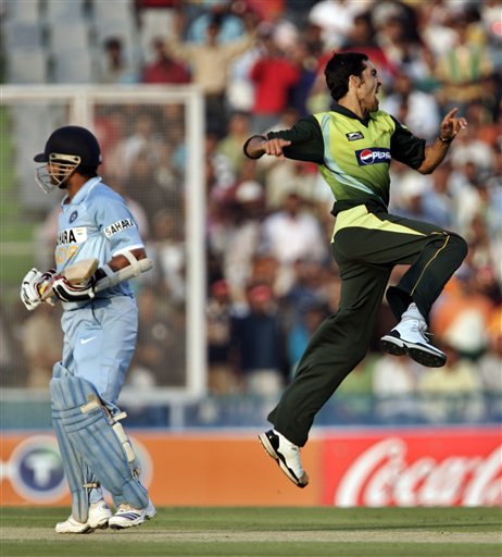 Pakistan's Umar Gul, right, celebrates the dismissal of India's Sachin Tendulkar during the second one day international cricket match in Mohali, India, Thursday, Nov. 8, 2007. Ind v Pak - 2nd ODI