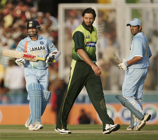 Sachin Tendulkar, left and Gautam Gambhir, right, complete their run as Pakistan's Shahid Afridi looks on during the second one day international cricket match in Mohali, India, Thursday, Nov. 8, 2007 Ind v Pak - 2nd ODI