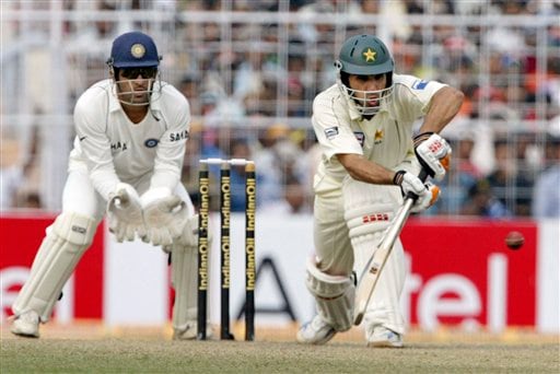 Misbah-ul Haq plays a shot as Indian wicket keeper Mahendra Dhoni reacts during the third day of the second Test match in Kolkata on Sunday, December 2, 2007. 2nd Test, Ind vs Pak - Day 3