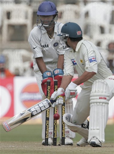 Pakistan team captain Younis Khan, right, is clean bowled by India's Harbajan Singh, unseen, as India's Dinesh Karthik looks on during the third day of their final Test in Bangalore Monday, Dec 10, 2007. India leads the series 1-0. 3rd Test, Ind vs Pak - Day 3