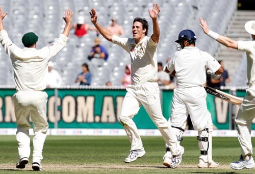 Mitchell Johnson, center, celebrates taking the final wicket of RP Singh, right, during the fourth day of their first Test match at the Melbourne Cricket Ground on Saturday, December 29, 2007. Australia won the match by 337 runs. 1st Test, Ind vs Aus - Day 4