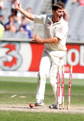 Brad Hogg celebrates after Michael Hussey runs out Harbhajan Singh for no score during the fourth day of their first Test match at the Melbourne Cricket Ground on Saturday, December 29, 2007. 1st Test, Ind vs Aus - Day 4