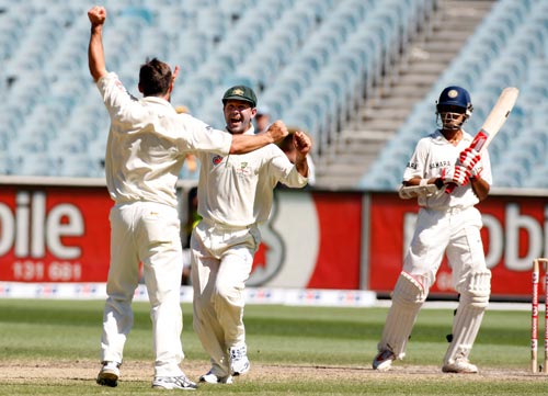 Brad Hogg, left, and Ricky Ponting celebrate after taking the wicket of Sourav Ganguly, right, during the fourth day of their first Test match at the Melbourne Cricket Ground on Saturday, December 29, 2007. 1st Test, Ind vs Aus - Day 4