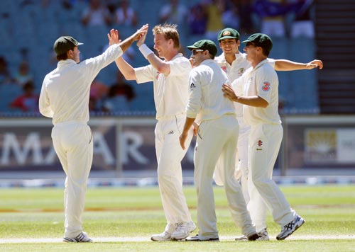 Brett Lee, center, celebrates with the team-mates after dismissing Wasim Jaffer during the fourth day of their first Test match at the Melbourne Cricket Ground on Saturday, December 29, 2007. 1st Test, Ind vs Aus - Day 4