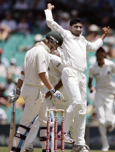 Michael Clarke, left, lowers his head as Harbhajan Singh celebrates taking Clark’s wicket. LBW, for 1 run at the Sydney Cricket Ground on Wednesday, January 2, 2008, on the first day of their second cricket Test. 2nd Test, Ind vs Aus - Day 1