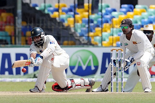 Mohammad Yousuf plays a shot as Kumar Sangakkara looks on during the third day of the third and final Test match between Sri Lanka and Pakistan at The Sinhalese Sports Club in Colombo. (AFP Photo) Pak vs SL: 3rd Test, Day 3