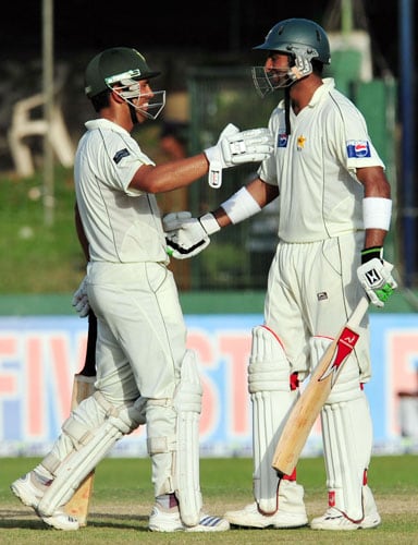 Shoaib Malik is congratulated by his teammate Kamran Akmal after scoring a century during the third and final Test match between Sri Lanka and Pakistan at The Sinhalese Sports Club in Colombo. (AFP Photo) Pak vs SL: 3rd Test, Day 3