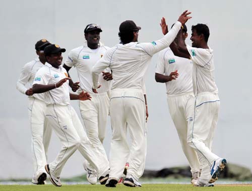 Nuwan Kulasekara celebrates with teammates the dismissal of Misbah-ul-Haq during the first day of the second Test match between Pakistan and Sri Lanka at The P. Saravanamuttu Stadium in Colombo. (AFP Photo) Day 1: Pak vs SL, 2nd Test