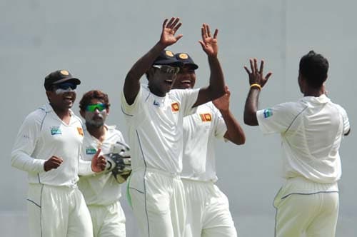 Nuwan Kulasekara celebrates with teammates the dismissal of Khurram Manzoor during the first day of the second Test match between Pakistan and Sri Lanka at The P. Saravanamuttu Stadium in Colombo. (AFP Photo) Day 1: Pak vs SL, 2nd Test