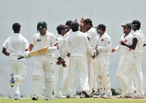 Thilan Thushara celebrates with teammates the dismissal of Kamran Akmal during the first day of the second Test match between Pakistan and Sri Lanka at The P. Saravanamuttu Stadium in Colombo. (AFP Photo) Day 1: Pak vs SL, 2nd Test