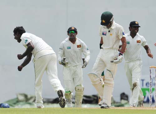 Angelo Mathews celebrates the dismissal of Fawad Alam with teammates during the first day of the second Test match between Pakistan and Sri Lanka at The P. Saravanamuttu Stadium in Colombo. (AFP Photo) Day 1: Pak vs SL, 2nd Test
