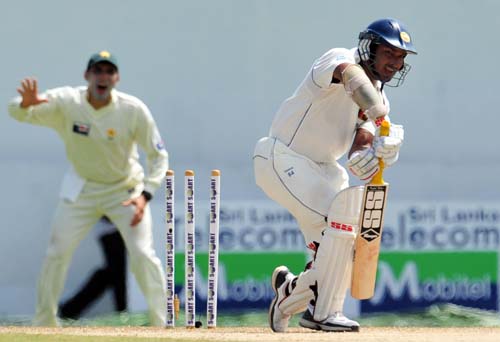 Kumar Sangakkara is dismissed by pacer Umar Gul as Misbah-ul-Haq looks on during the second day of the second Test match between Pakistan and Sri Lanka at The P. Saravanamuttu Stadium in Colombo. (AFP Photo) Day 2: Pak vs SL, 2nd Test