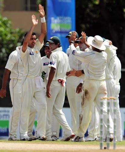 Umar Gul celebrates the dismissal of Kumar Sangakkara with teammates during the second day of the second Test match between Pakistan and Sri Lanka at The P. Saravanamuttu Stadium in Colombo. (AFP Photo) Day 2: Pak vs SL, 2nd Test