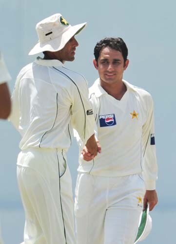 Saeed Ajmal is congratulated by his teammate Younus Khan after dismissing Angelo Mathews during the second day of the second Test match between Pakistan and Sri Lanka at The P. Saravanamuttu Stadium in Colombo. (AFP Photo) Day 2: Pak vs SL, 2nd Test